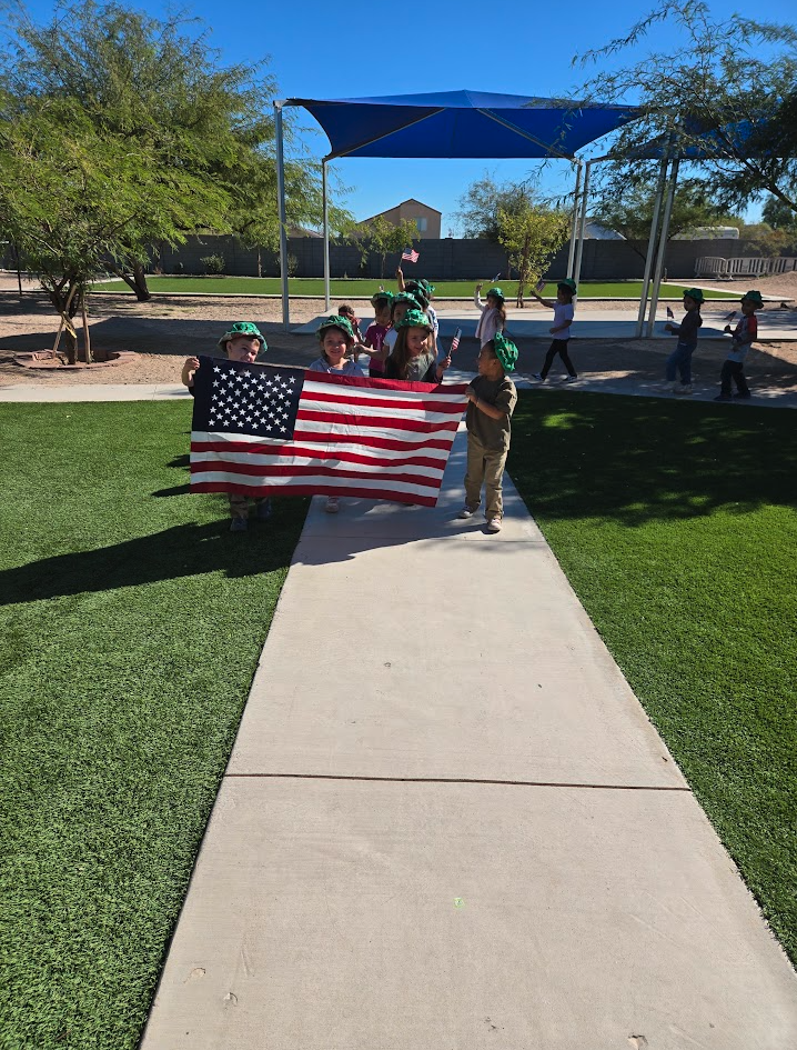 Children carrying an American flag during a patriotic parade
