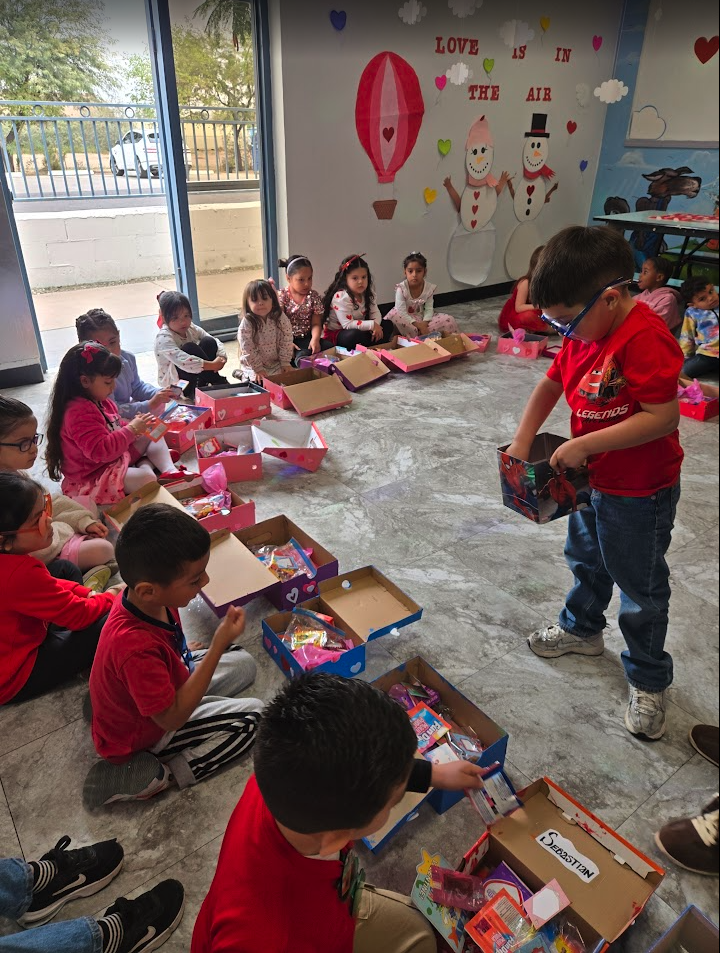 Children exchanging decorated boxes during a Valentine's Day party